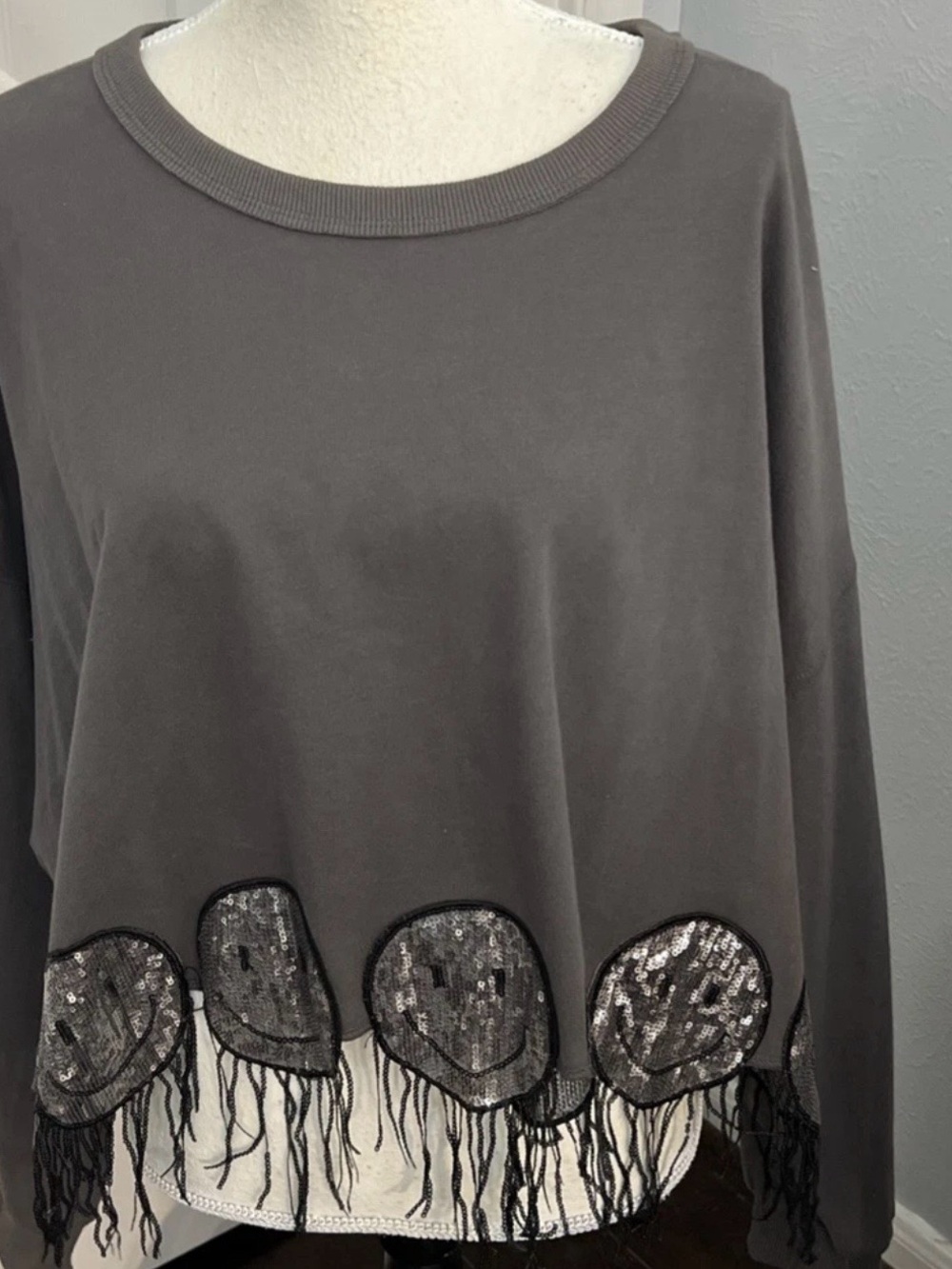 Peach Love California Charcoal Gray Fringe Hem Top with silver smiles on the bot
